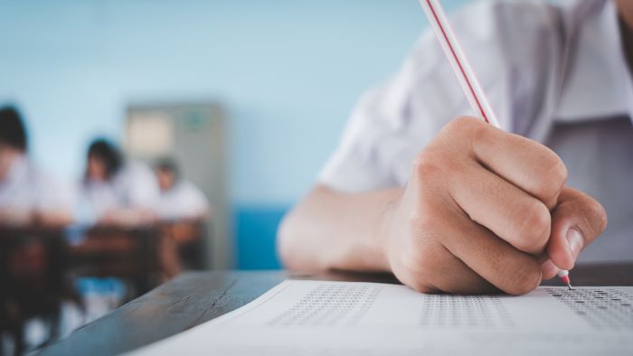 Recomposição de aprendizagem: como reduzir as perdas da pandemia 2 Foto de estudante resolvendo teste de avaliação diagnóstica, que é uma das estratégias de recomposição de aprendizagem.