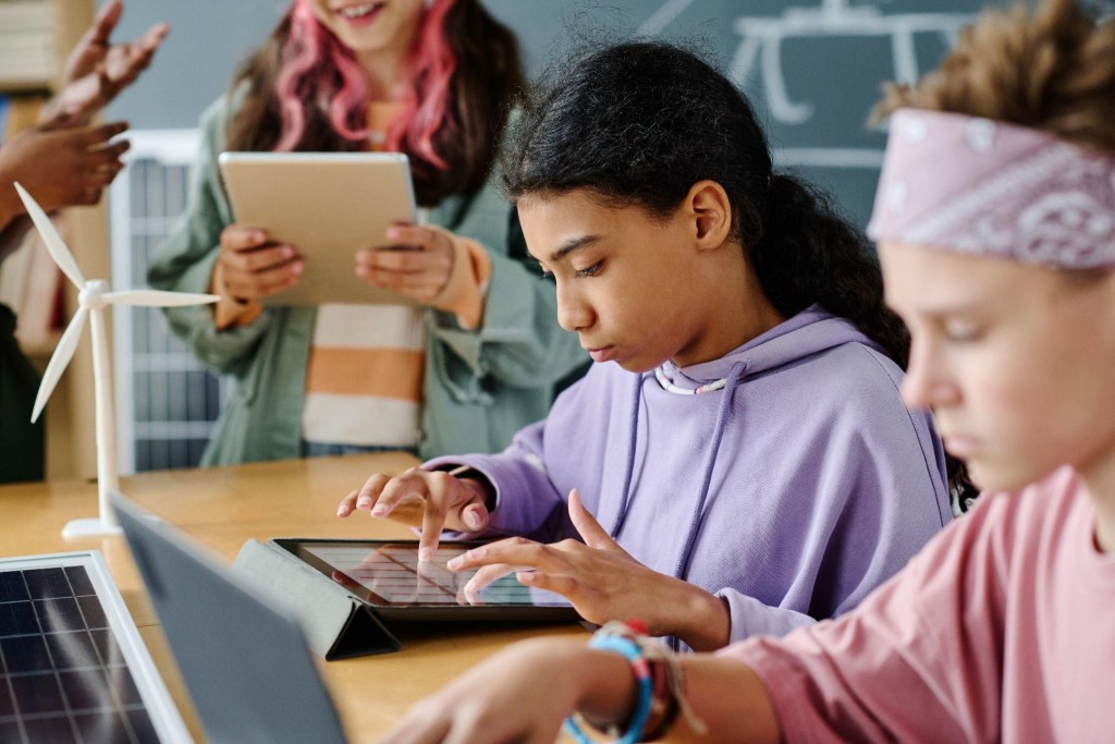 Habilidades do século XXI: quais são, por que importam e como desenvolver na escola 1 foto de adolescentes usando a tecnologia na escola